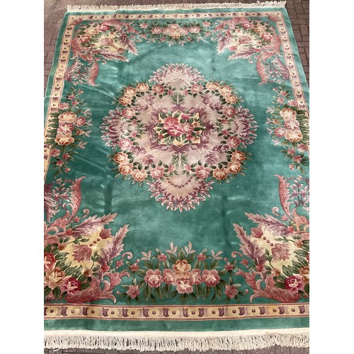 190 - A Chinese Shensi deep pile woolen rug, in rich jade green, with floral medallion and corners in tone... 