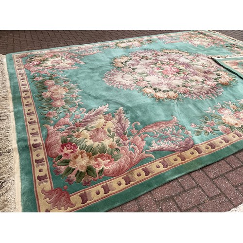 190 - A Chinese Shensi deep pile woolen rug, in rich jade green, with floral medallion and corners in tone... 