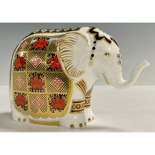 2 - A Royal Crown Derby paperweight, Elephant, printed in the 1128 pattern, trunk raised, gold 21st anni... 