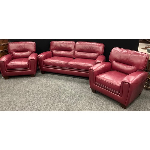 204 - An ‘Italia Lucca’ type model red leather three seat sofa, and matching pair of armchairs - the sofa ... 