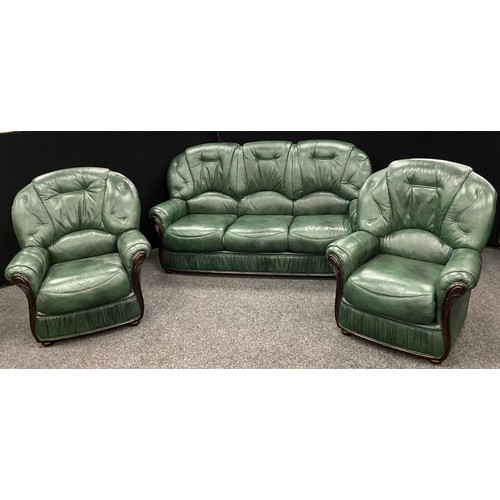 209 - An Italian style deep green leather and mahogany three seat sofa, and matching pair of armchairs - t... 