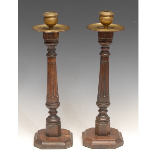 93 - A pair of early 20th century candlesticks, brass sconces and drip pans, fluted pillars, canted squar... 