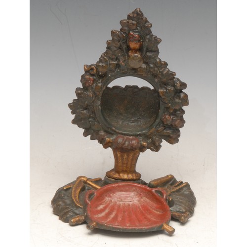 96 - A 19th century cast iron pocket watch stand, cast with pastoral regalia, 16cm high, c.1860