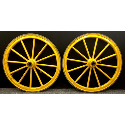 233 - A pair of vintage twelve-spoke wooden cart wheels, iron rims, 95cm diameter.