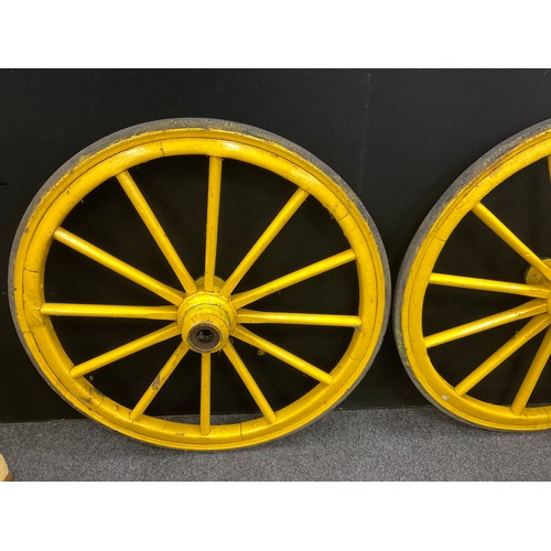 233 - A pair of vintage twelve-spoke wooden cart wheels, iron rims, 95cm diameter.