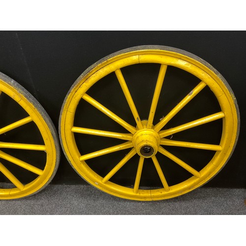 233 - A pair of vintage twelve-spoke wooden cart wheels, iron rims, 95cm diameter.