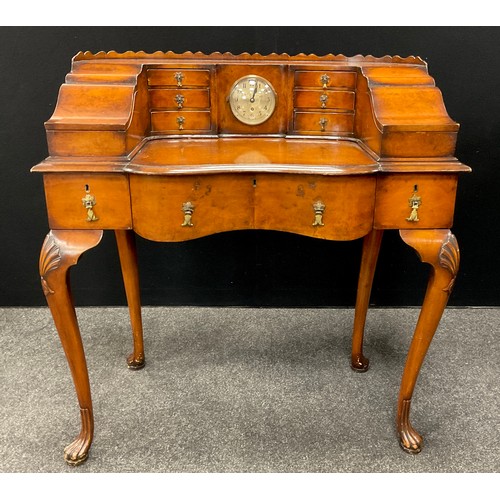 182 - A Carlton House style walnut writing desk, the galleried super structure set with clock to centre, f... 