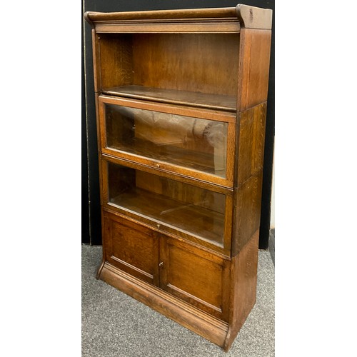 191 - A Globe Werncke type oak four tier bookcase / cabinet, comprised of five sections - pediment, three ... 