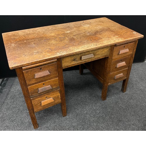 216 - An oak knee-hole desk, 77cm high x 122.5cm wide x 67.5cm deep, c.1930.