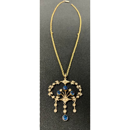 304 - An Edwardian seed pearl and blue stone three drop floral pendant necklace, unmarked yellow metal mou... 