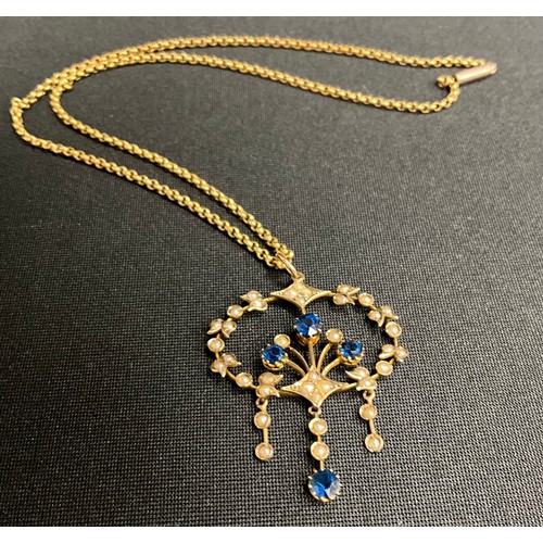 304 - An Edwardian seed pearl and blue stone three drop floral pendant necklace, unmarked yellow metal mou... 