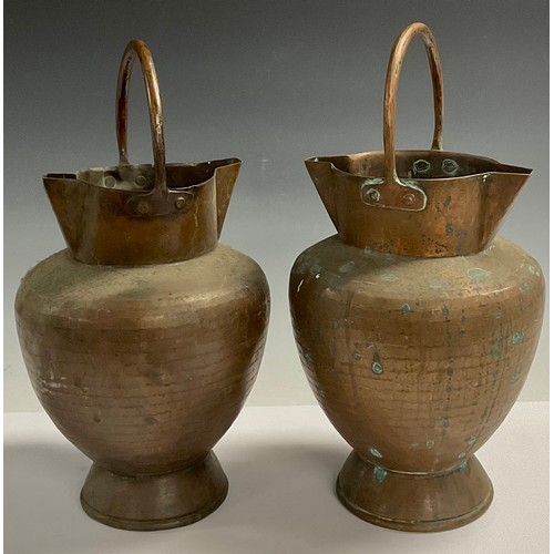 52 - A pair of Arts and Crafts copper double spout pails, planished throughout, fixed loop handles, 35cm,... 