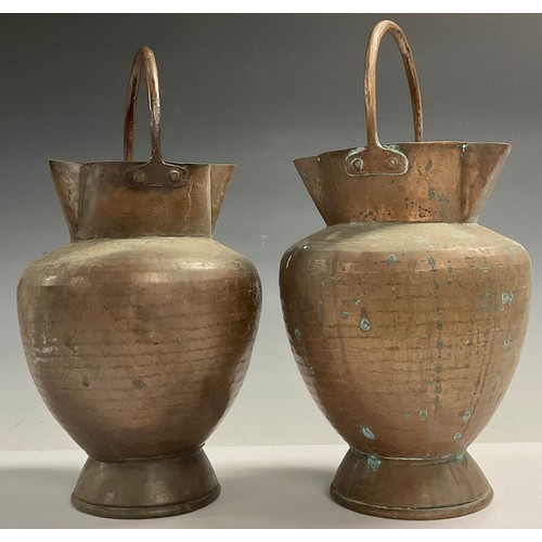 52 - A pair of Arts and Crafts copper double spout pails, planished throughout, fixed loop handles, 35cm,... 