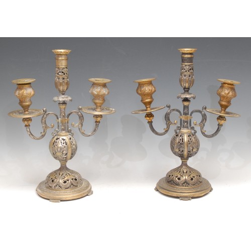 55 - A pair of 19th century Renaissance Revival parcel-gilt and silvered bronze three-light candelabra, p... 