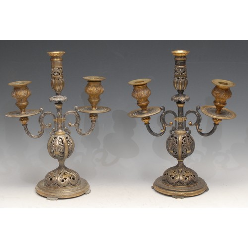 55 - A pair of 19th century Renaissance Revival parcel-gilt and silvered bronze three-light candelabra, p... 