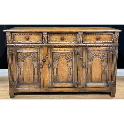 101 - A 17th century style oak low dresser or side cabinet, by Titchmarsh & Goodwin, 84cm high, 137cm wide... 