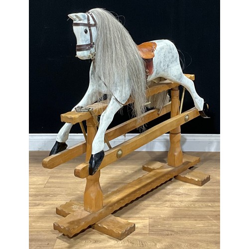 493 - A Victorian style painted wooden rocking horse, arm and cradle mechanism, 98cm high, mid to late 20t... 