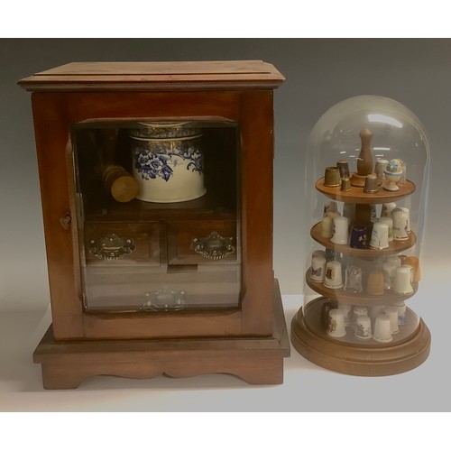 502 - An Edwardian mahogany smoker’s cabinet, the bevelled glass door enclosing a 19th century tobacco jar... 