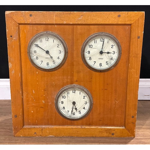 562 - A Gents’ of Leicester three clock distribution board, the hinged cover enclosing switchboards and an... 