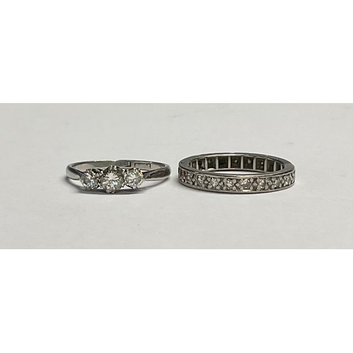 594 - An 18ct white gold and platinum three stone diamond ring, size O/P, 2g, marks rubbed; an unmarked wh... 