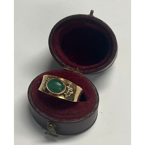 596 - A 14ct gold ring, set with a single polished oval jade cabochon, size N, 2.6g, boxed