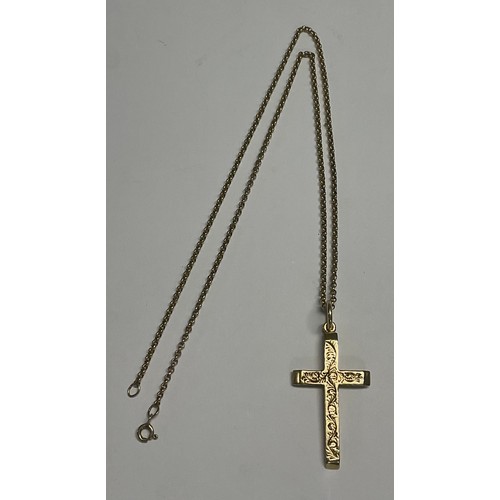 612 - A 9ct gold cross pendant, marked 375, suspended from a 9ct gold necklace chain, 10.5g