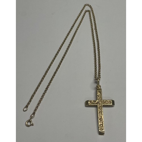 612 - A 9ct gold cross pendant, marked 375, suspended from a 9ct gold necklace chain, 10.5g