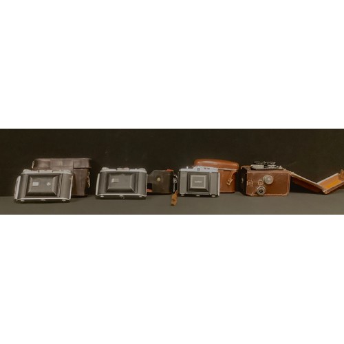 653 - A Toyocaflex twin lens camera, Tri-Lausar lenses, numbers 645191 and 644092, brown leather case; a Z... 