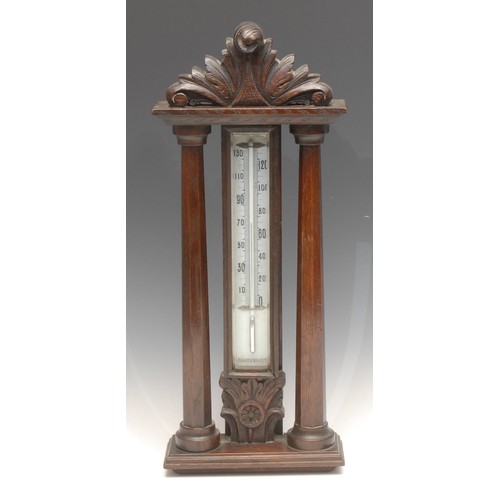 677 - A Victorian oak wall mounted thermometer, Fahrenheit scale, mercury cistern, carved architectural ca... 