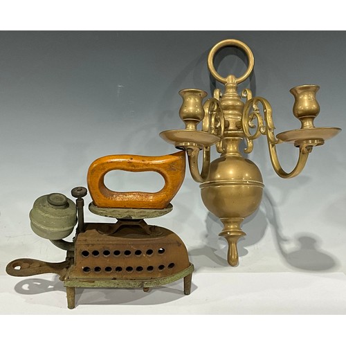 689 - A 19th century Dutch two branch candle sconce; A Spirit Fires flat iron and trivet