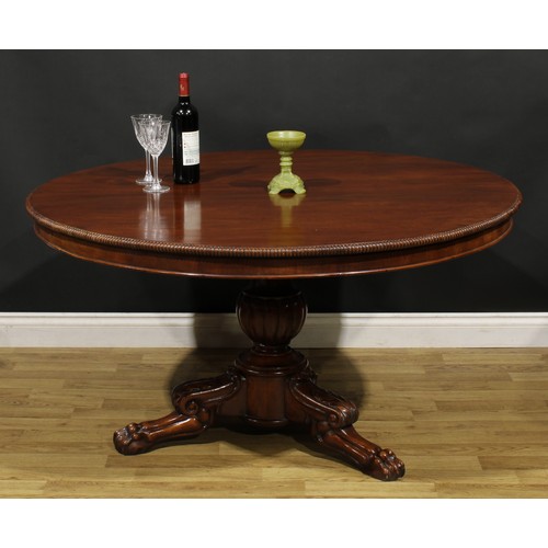 1391 - A 19th century mahogany centre table, possibly Irish, circular tilting top with reel moulded edge, b... 