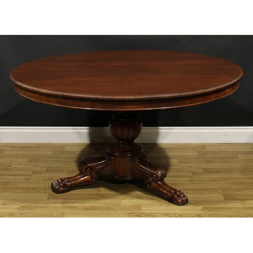 1391 - A 19th century mahogany centre table, possibly Irish, circular tilting top with reel moulded edge, b... 