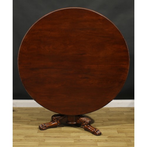 1391 - A 19th century mahogany centre table, possibly Irish, circular tilting top with reel moulded edge, b... 