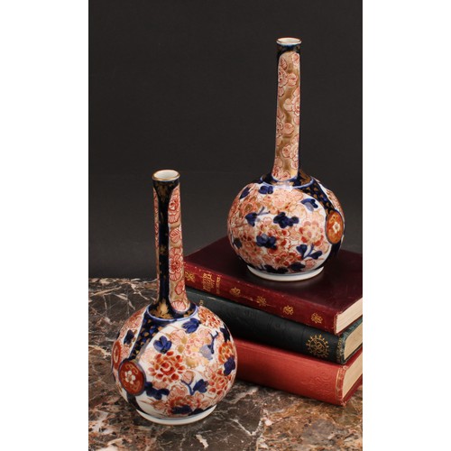 269 - A pair of Japanese porcelain bottle vases, decorated in the Imari palette with peonies and chrysanth... 