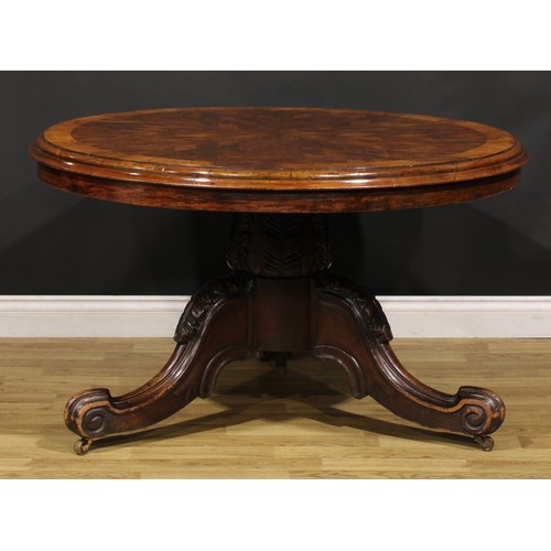 1439 - A Victorian mahogany and rosewood parquetry centre table, circular tilting top with segmented veneer... 