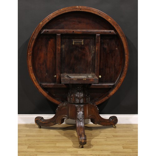 1439 - A Victorian mahogany and rosewood parquetry centre table, circular tilting top with segmented veneer... 