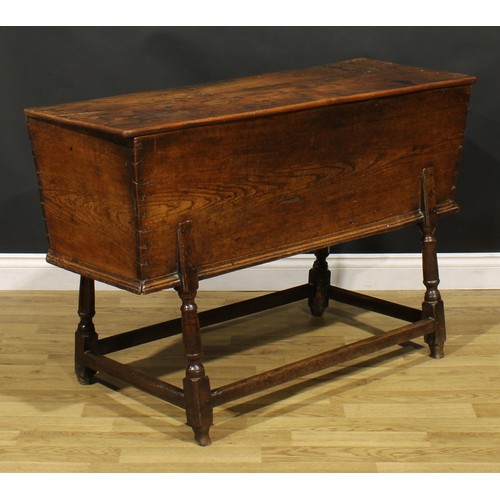 1362 - An 18th century elm dough bin, the base with turned legs, 76cm high, 121cm wide, 45cm deep