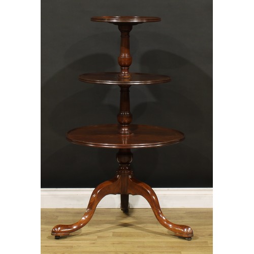 1405 - A George III Revival mahogany three-tier dumbwaiter, dished circular plateaux, turned supports, cabr... 