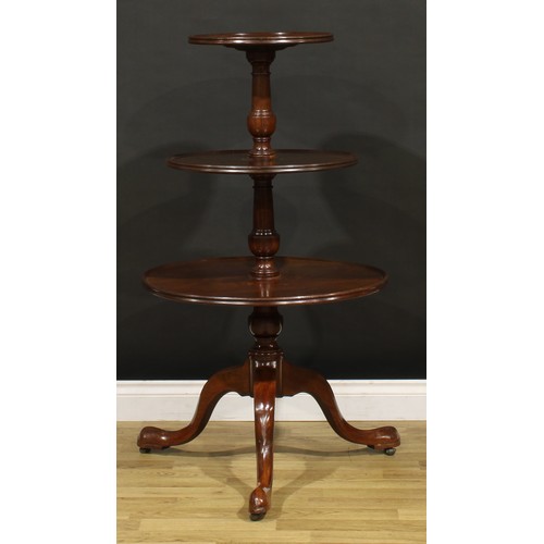 1405 - A George III Revival mahogany three-tier dumbwaiter, dished circular plateaux, turned supports, cabr... 