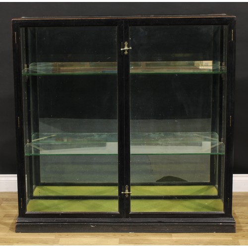 1415 - A late Victorian ebonised shop display cabinet or showcase, mirrored back, F. Sage & Co’s patent han... 