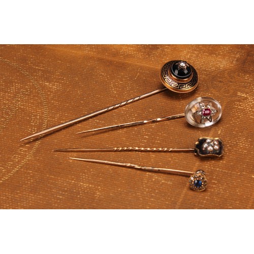 969 - Stick Pins - a 19th century diamond and ruby set polished oval rock crystal stick pin, set with a st... 