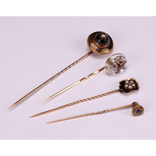 969 - Stick Pins - a 19th century diamond and ruby set polished oval rock crystal stick pin, set with a st... 