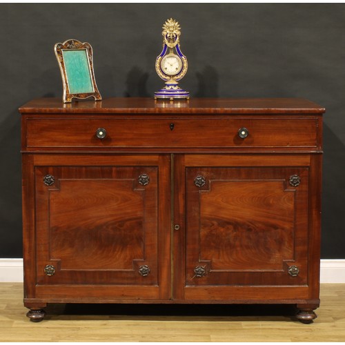 1411 - A George IV mahogany bachelor’s chamber dressing cabinet, slightly oversailing rectangular top above... 