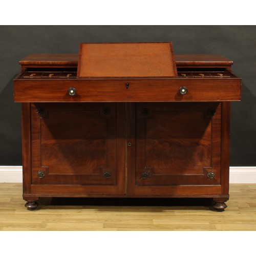 1411 - A George IV mahogany bachelor’s chamber dressing cabinet, slightly oversailing rectangular top above... 