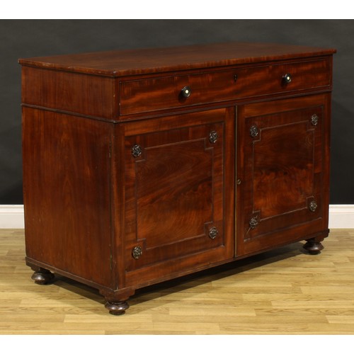 1411 - A George IV mahogany bachelor’s chamber dressing cabinet, slightly oversailing rectangular top above... 