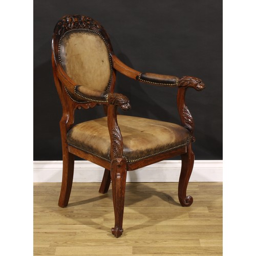 1541 - A pair of 19th century Anglo-Indian colonial padouk elbow chairs, each cresting rail carved with an ... 