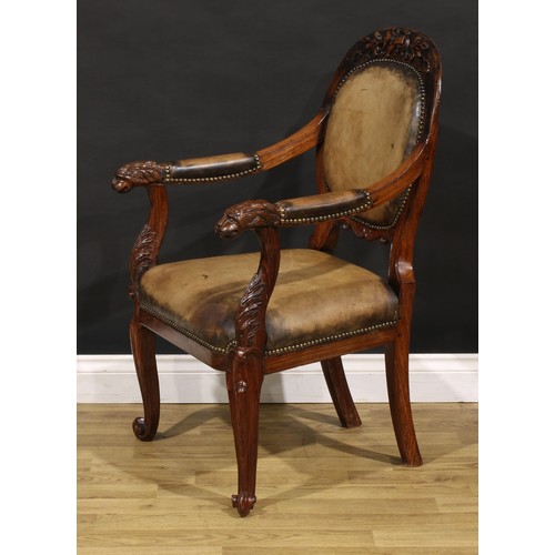 1541 - A pair of 19th century Anglo-Indian colonial padouk elbow chairs, each cresting rail carved with an ... 