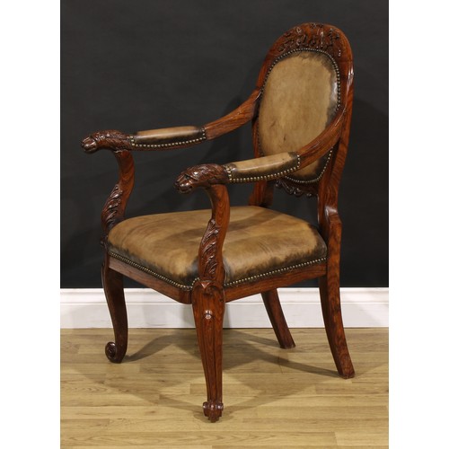 1541 - A pair of 19th century Anglo-Indian colonial padouk elbow chairs, each cresting rail carved with an ... 