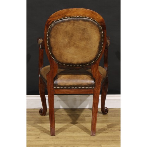 1541 - A pair of 19th century Anglo-Indian colonial padouk elbow chairs, each cresting rail carved with an ... 