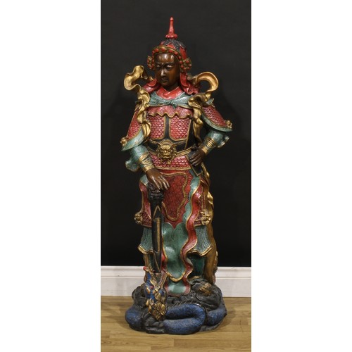 275 - A large painted bronze, of a Japanese warrior, he stands in battle dress with a dragon at his feet, ... 